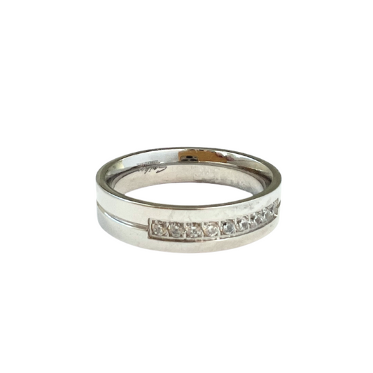 Stainless steel ring with an inlay of 9 clear gems at the front of the band.