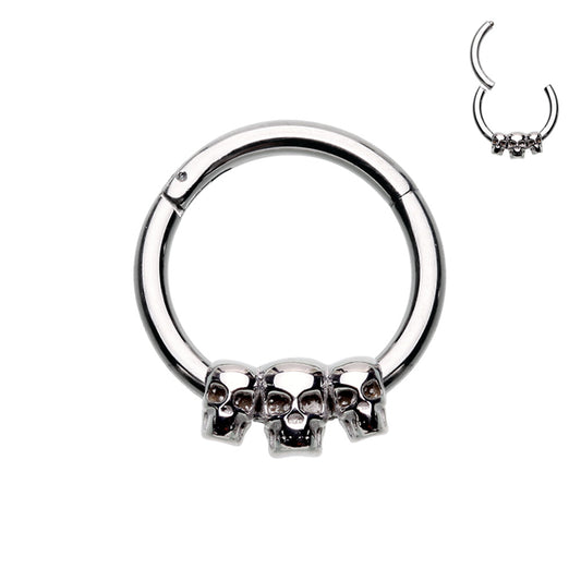 316L Surgical steel hinged segment ring with 3 small skulls in steel. Great for septum or cartilage.  These hinged clickers can be used for eyebrow, lip, earlobes, daith, rook, snug, helix or septum.