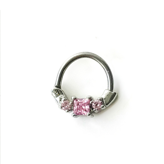 Hinged segment ring with 3 prong set pink cubic zirconia gems. 16 gauge X 8mm. This clicker is on the small side, for a snug fit. This segment ring is great for septum, daith, or other cartilage piercings. Bar is surgical steel, dangle material is plated brass.