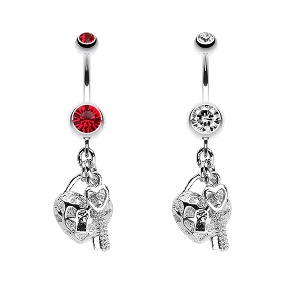 Two surgical steel dangling belly button rings with filigree heart lock and key charms, featuring red and clear round crystal accents on a white background.