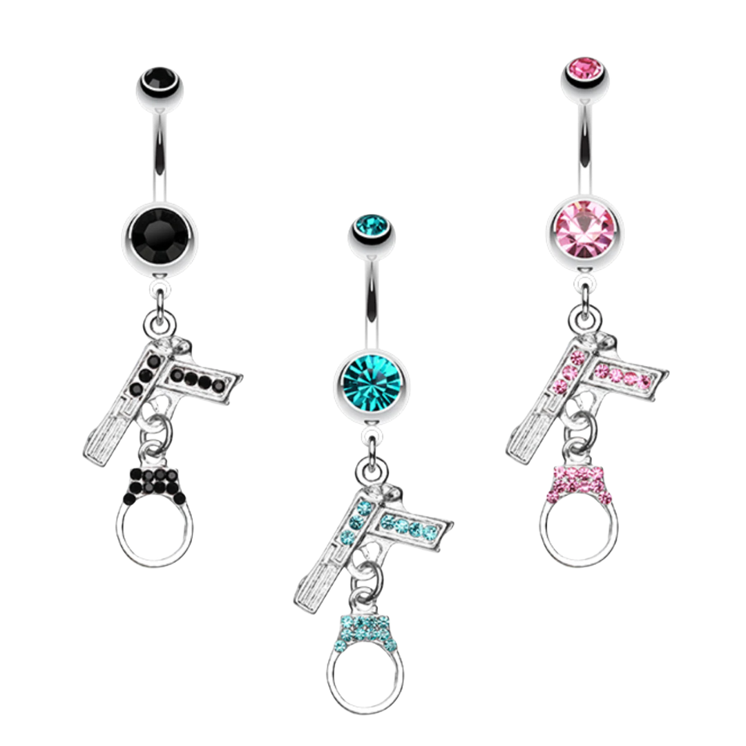 Three surgical steel belly rings with dangling charms, shown on a plain white background. Each piece has a round gemstone at the top and a dangling cross charm with small stones; one is black, one is turquoise blue, and one is pink.