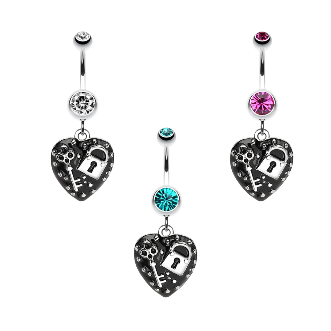 Three surgical steel belly rings with heart-shaped lockpicks and keychains, featuring rhinestone details and colored gemstone accents in silver, clear, turquoise, and pink, displayed on a solid white background.
