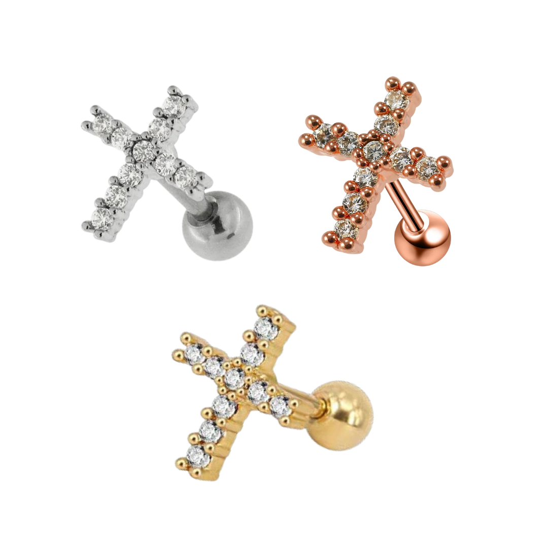 Three cross-shaped stud cartilage earrings with clear gemstones, shown in surgical steel, rose gold and gold plated finishes on a plain white background.