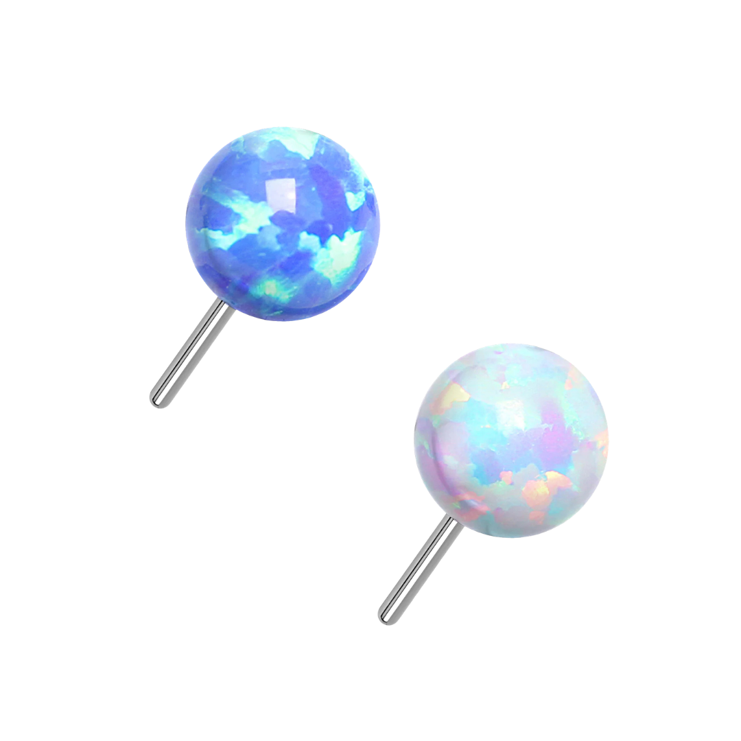 Two round titanium stud earrings with iridescent opal-like tops on posts, shown on a plain white background.