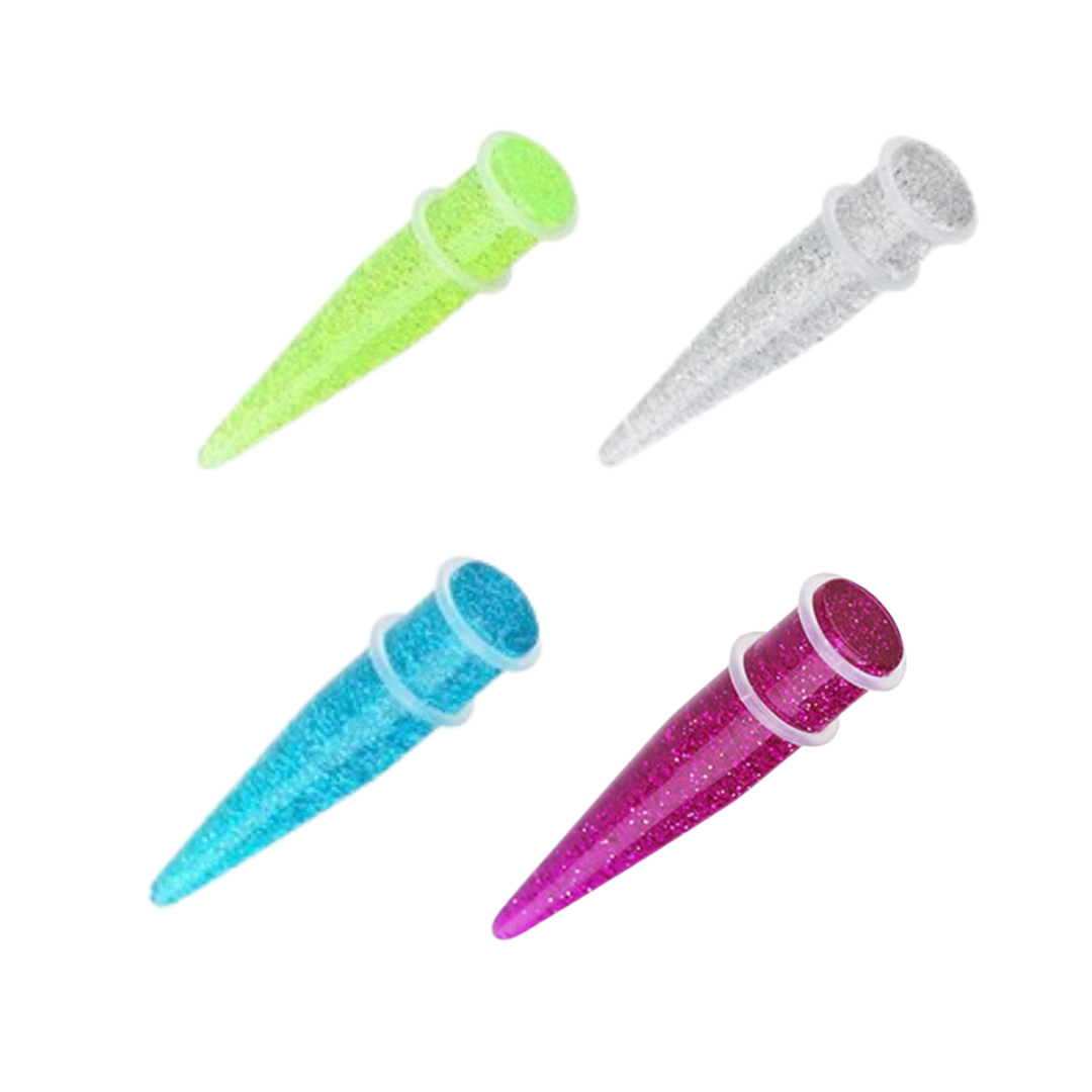 Four glitter cone-shaped ear stretchers in lime green, clear, light blue, and magenta, arranged on a plain white background.