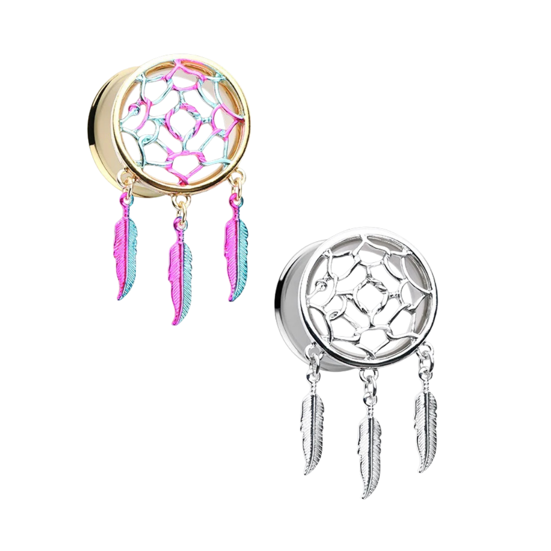 Two screw-fit flesh tunnels for stretched ear piercings on a white background, featuring an intricate webbed dreamcatcher center insert with three dangling feather charms; one tunnel is gold-plated with a multi-coloured pink, purple, and blue web, and the other is a uniform polished surgical steel.