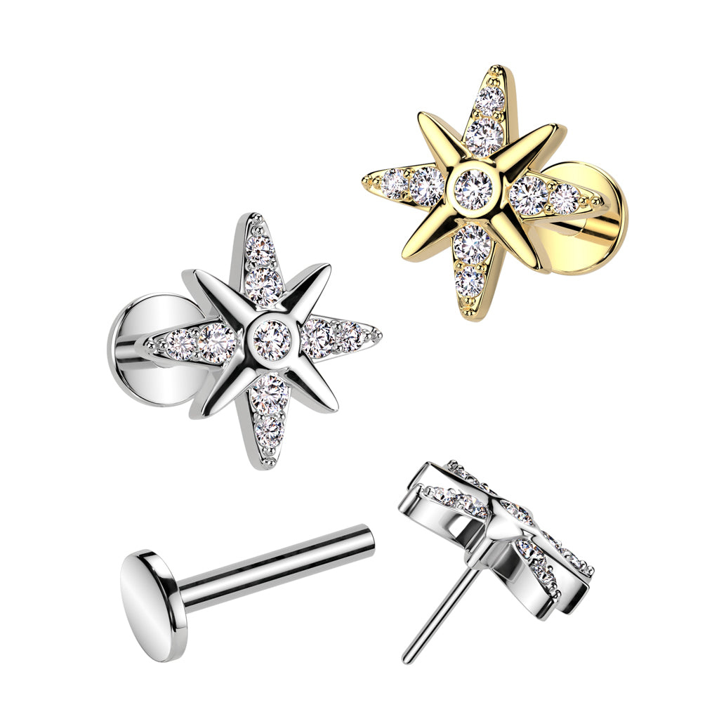 An image of a gold plated and two stainless steel flat back labret piercing stud featuring a crystal-paved starburst top.