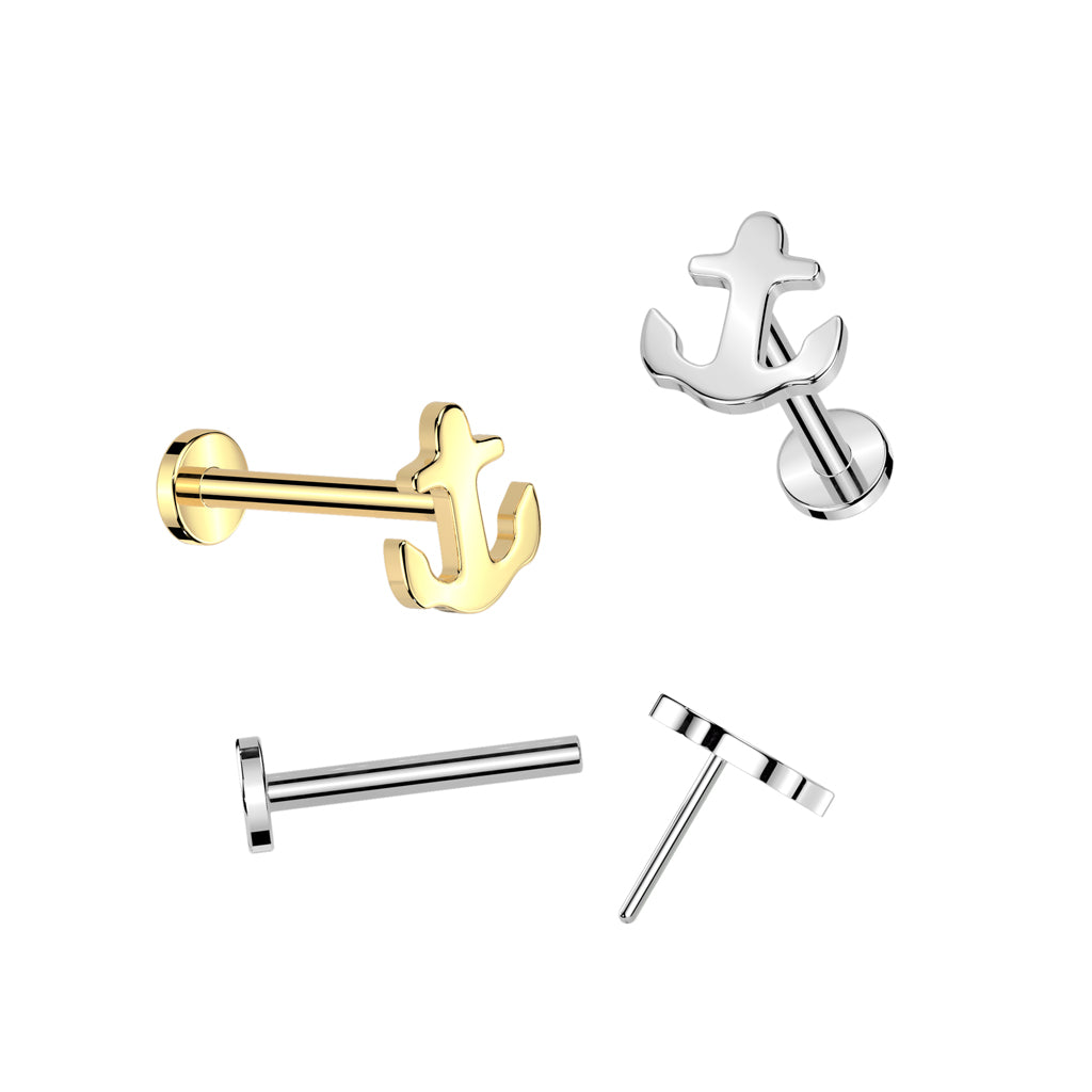Two flat-back labret stud piercing rings with decorative nautical anchor tops shown in gold plated and sterling silver finishes on a white background. Below them, a detached hollow post and a threadless anchor top with a pin demonstrate the push-pin assembly.