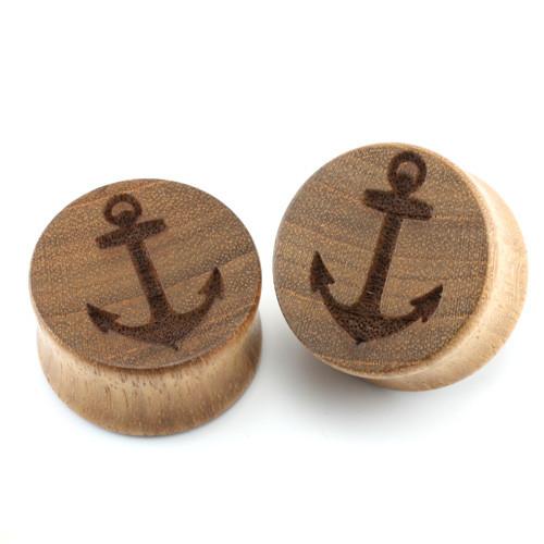Two wooden double flare plugs with carved anchor designs