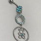 Cute surgical steel belly ring with a bottom gem shaped flower and a dangly small gem covered circle and a bear with a centre gem in a larger circle. Externally Threaded. Shown with light blue gems.