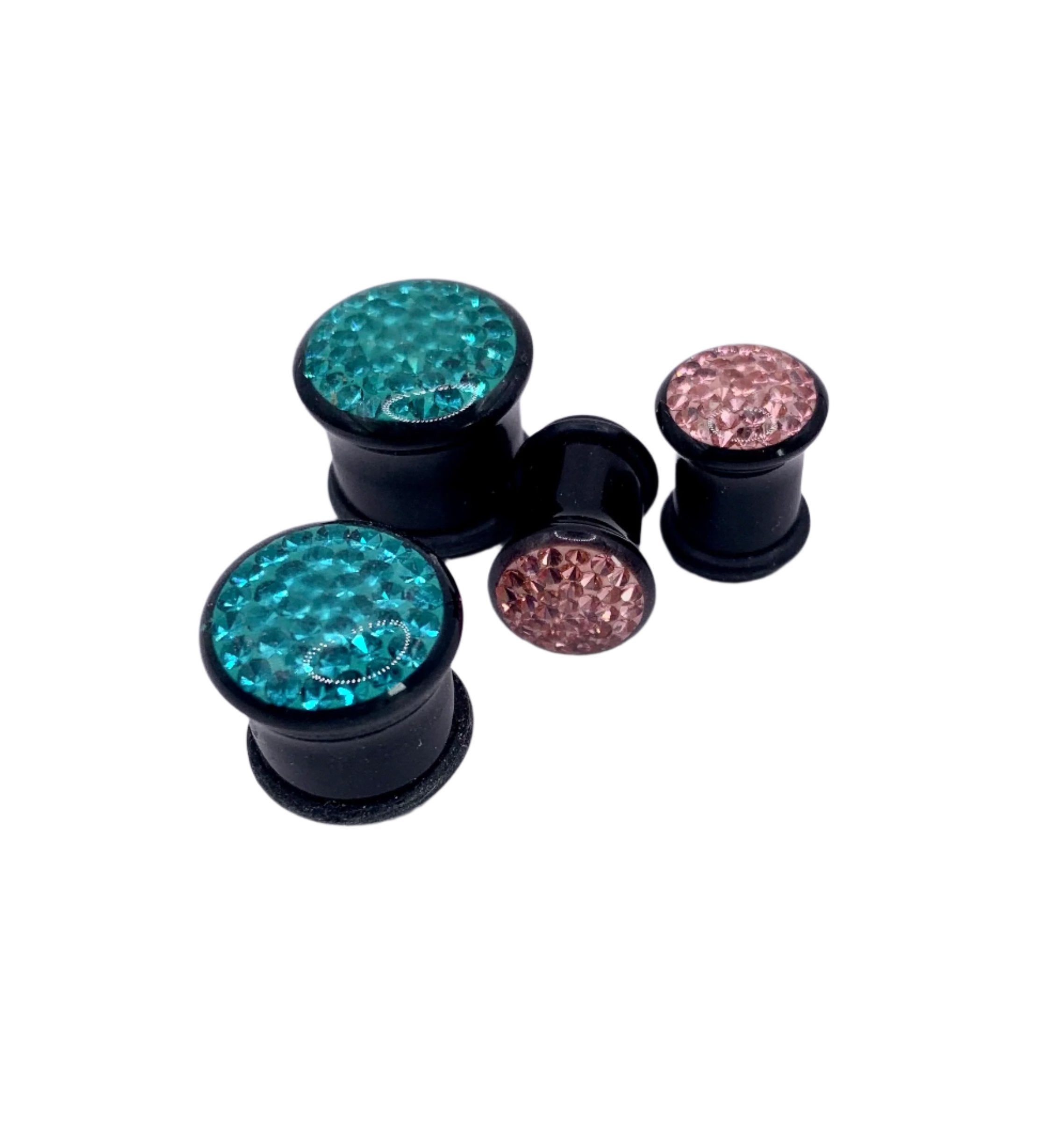 A collection of acrylic tiffany single flare plugs in various colors including blue, black, pink, and clear.