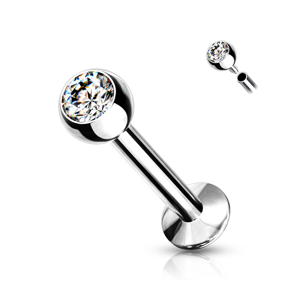 A surgical steel labret piercing stud featuring a clear bezel-set crystal gem.