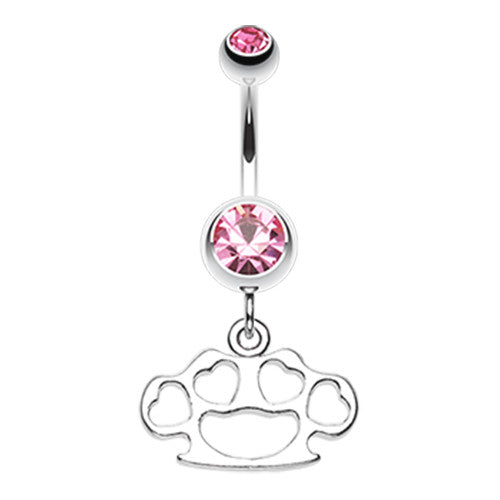 A stainless steel belly ring featuring brass knuckle charms and blue gem detailing.