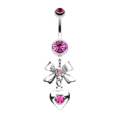 A surgical steel heart and bow belly ring with pink gemstones