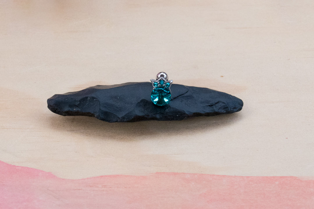 A  teal blue 316L surgical stainless steel cartilage barbell earring featuring a crown design with cubic zirconia gems.
