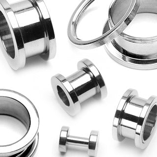 A collection of surgical steel ear tunnels and plugs in various sizes, displayed on a white background.