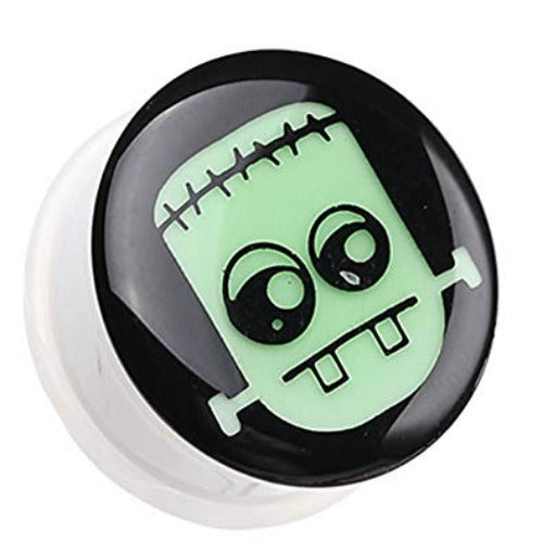 A glow in the dark Frankenstein acrylic single flare ear plug.