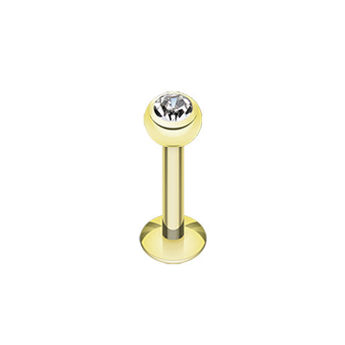 A gold plated labret stud featuring a clear gemstone ball