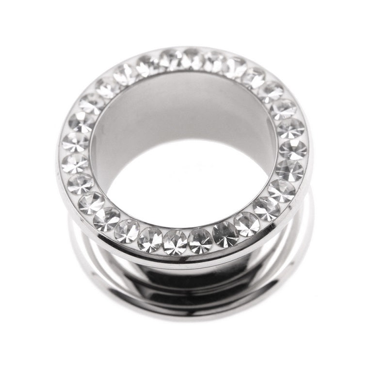 A single piece of jewelled tunnel with a machine head design, featuring clear gem stones set in a metallic band.