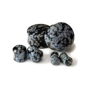 A pair of snowflake obsidian double flared plugs for ear tunnels, showing a black and gray color pattern.