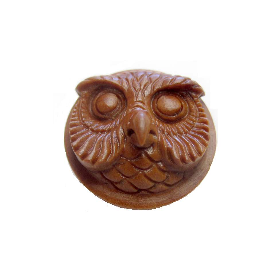 A wooden double flared plug with a carved owl head