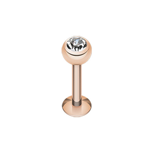 a rose gold labret piercing stud featuring a clear crystal gem.