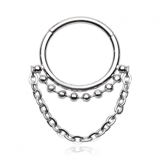 This 316L surgical steel segment clicker has a little extra with the additional tribal balls on the ring, and a dangly chain below. The rounded top of this hinged clicker makes it a great piece of jewellery for septum, daith, tragus, or rook piercings.